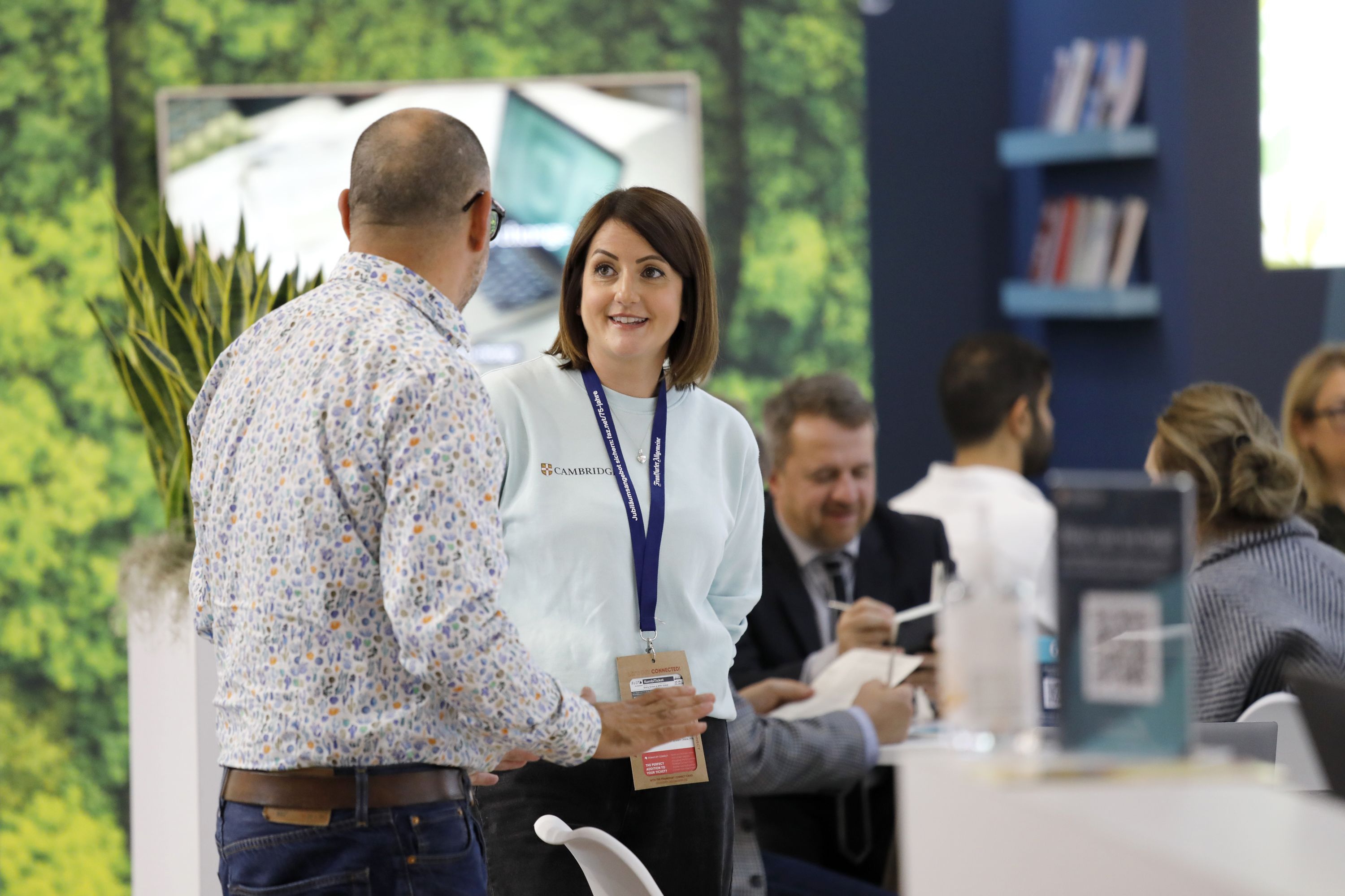 Visitors chatting with each other in the green zone of Cambridge stand at the 76th Frankfurt book fair