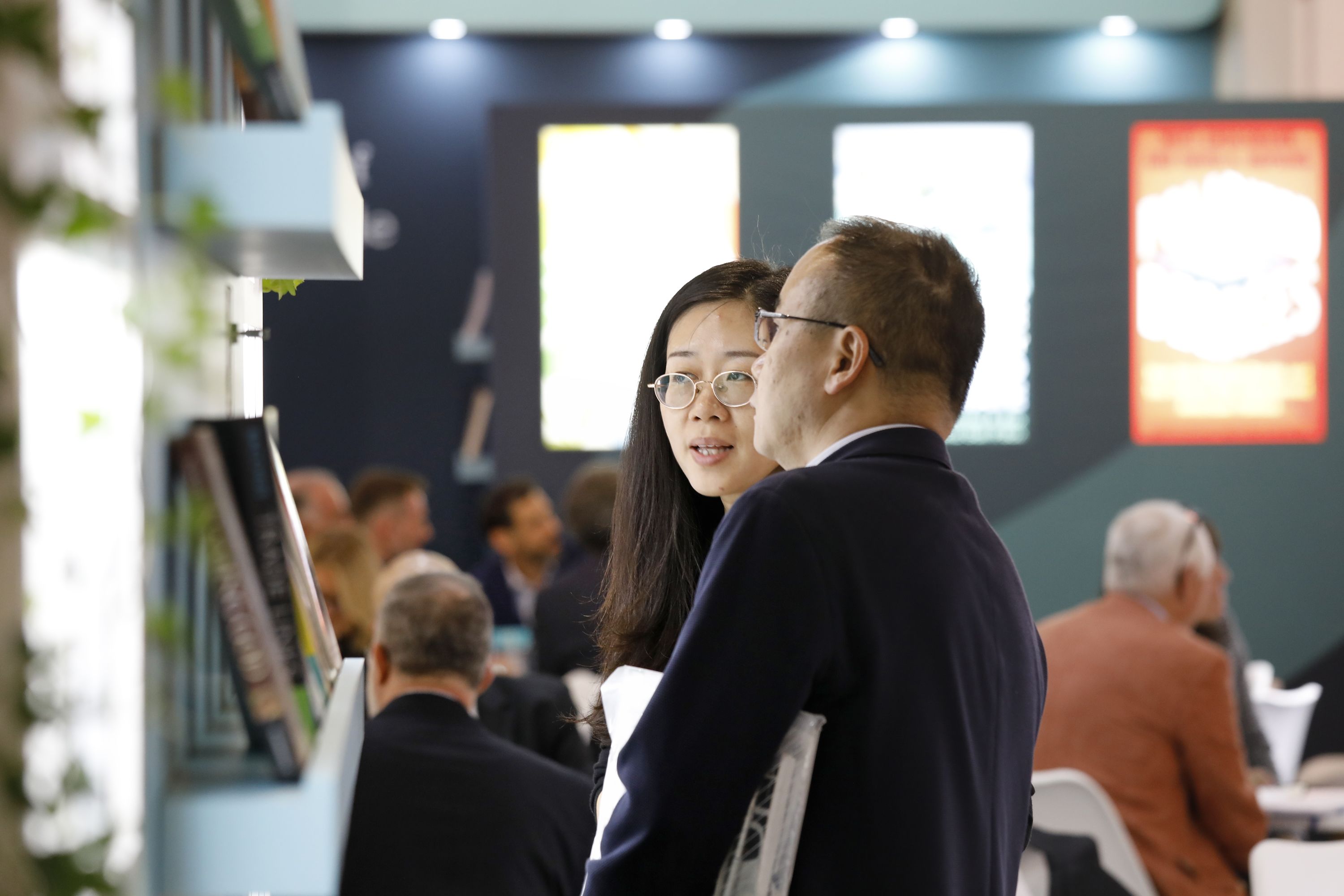 Two Asian visitors looking at Cambridge University Stand at Frankfurt Book Fair