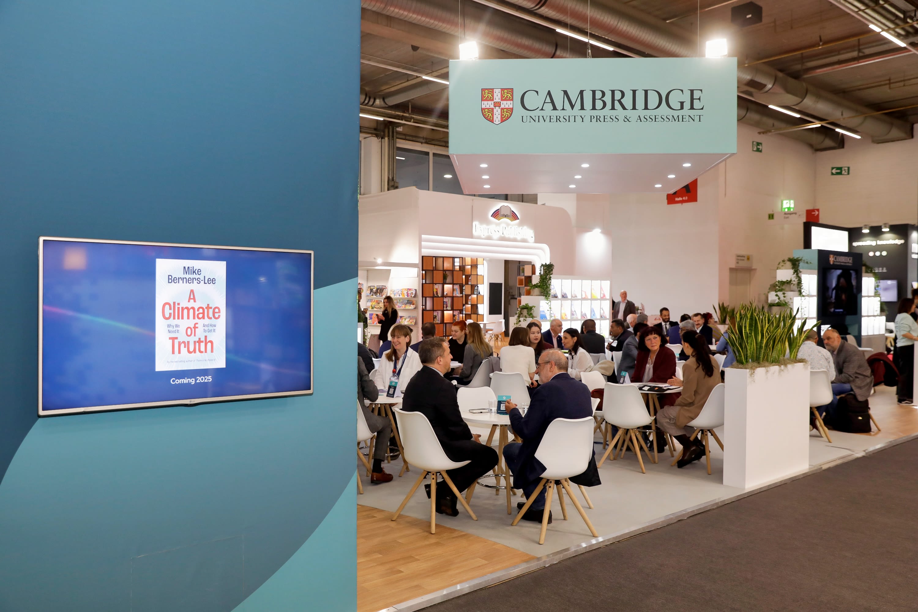 Cambridge University Press & Assessment zone at Frankfurt Book Fair, with the upcoming title 'A climate of truth' cover displayed on TV screen on the left