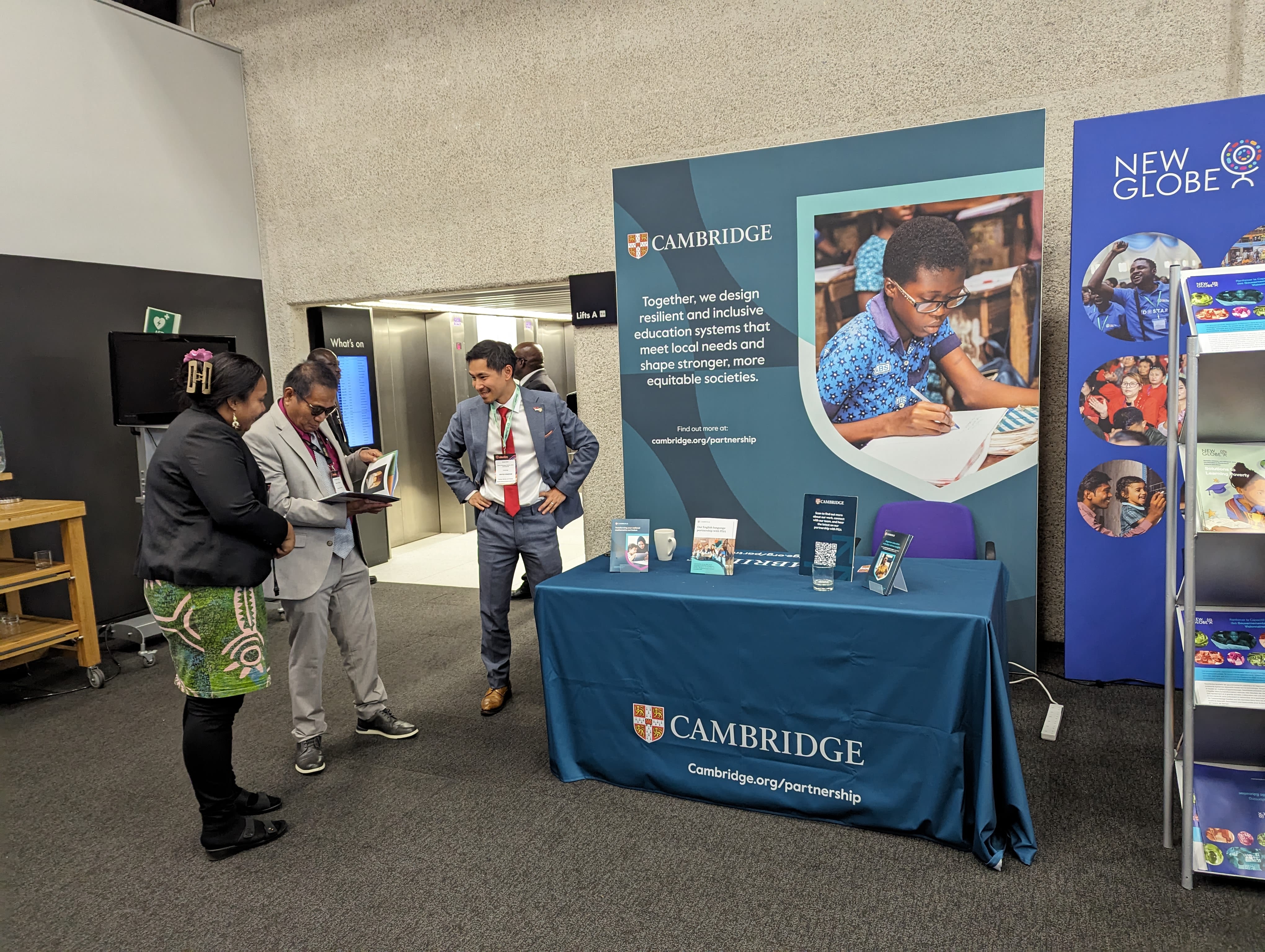 Visitors are reading leaflets displayed at Cambridge's stands in EWF 2024.